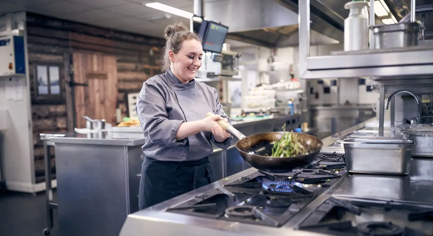 Kok bereidt wokgerecht in keuken